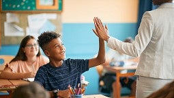 teacher greeting a student