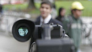 Video camera filming someone on campus